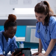 Nurse,Showing,Medical,Data,To,Young,Collegue,On,A,Digital