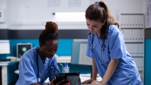 Nurse,Showing,Medical,Data,To,Young,Collegue,On,A,Digital